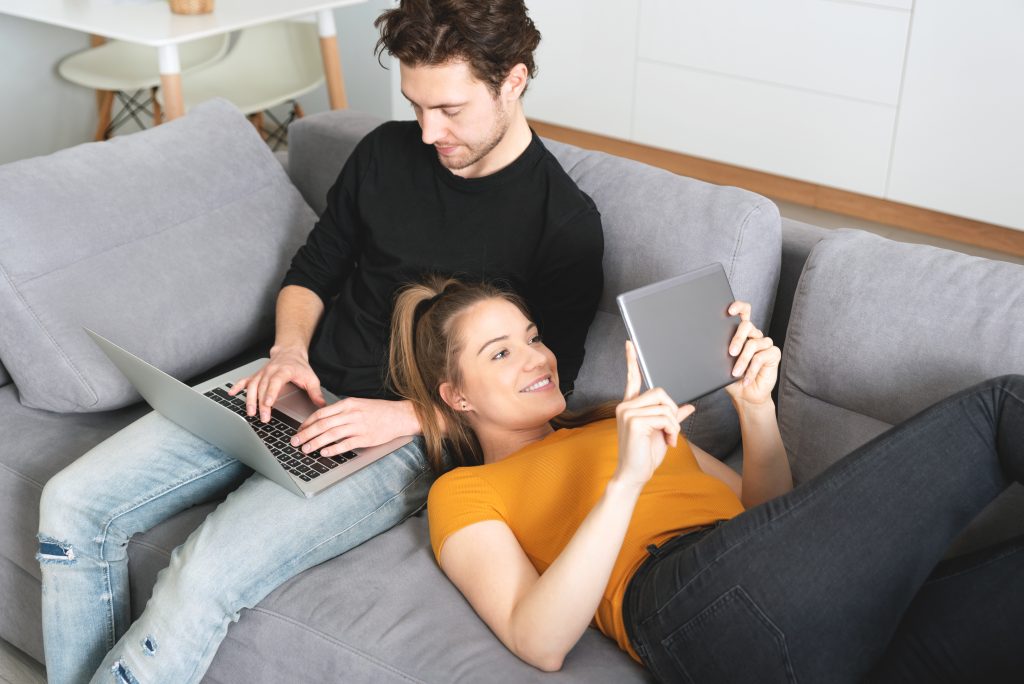 Happy couple enjoying streaming internet